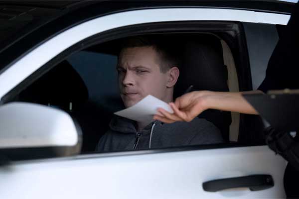 A man receiving an open container traffic ticket